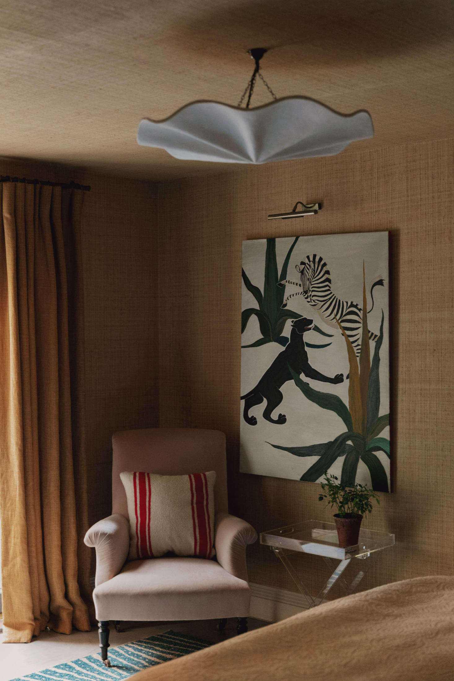 In the guest room, sea-grass wallpaper covers both the walls and the ceiling.