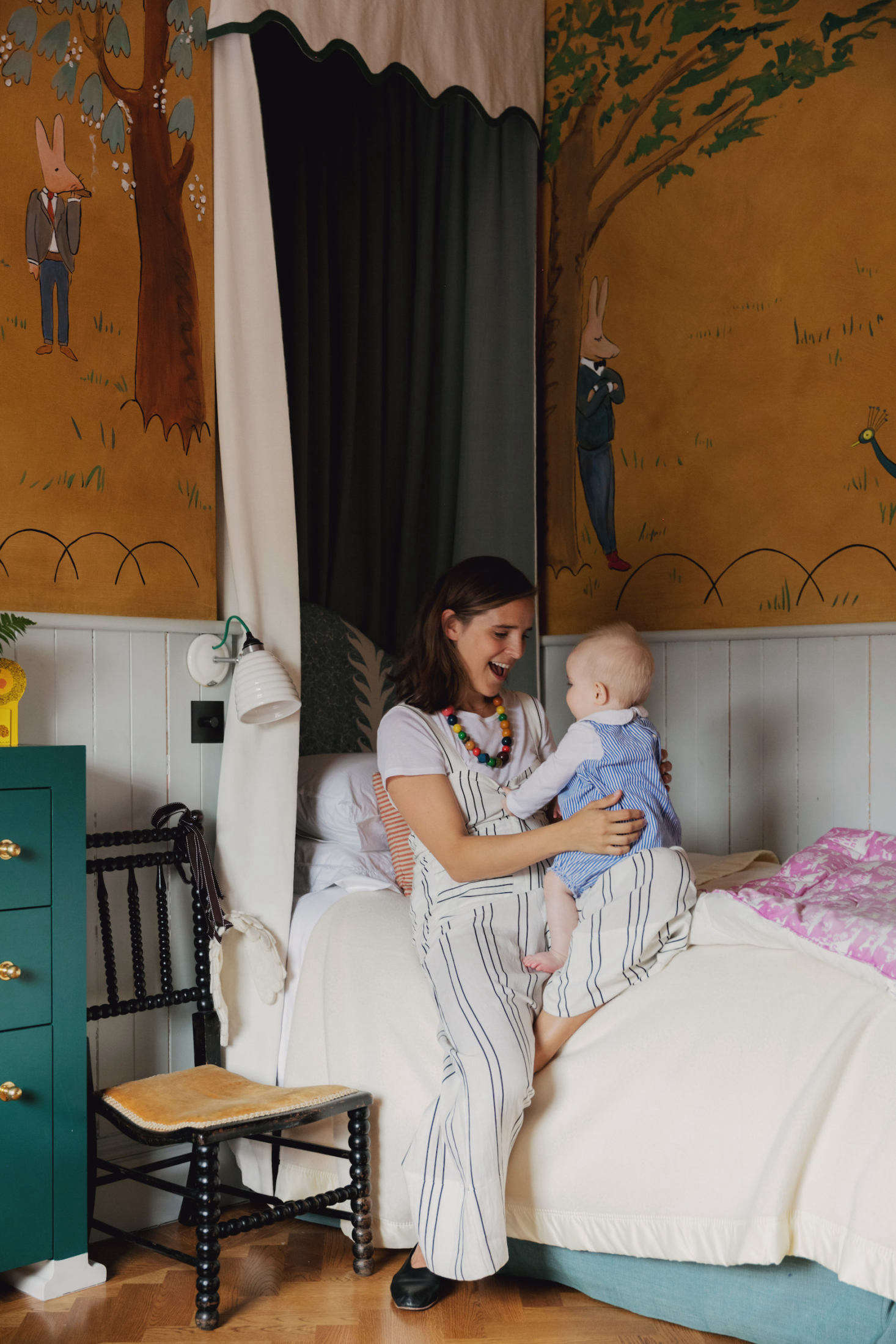 Heuman with her baby in the whimsical bedroom of her older daughter, a toddler.