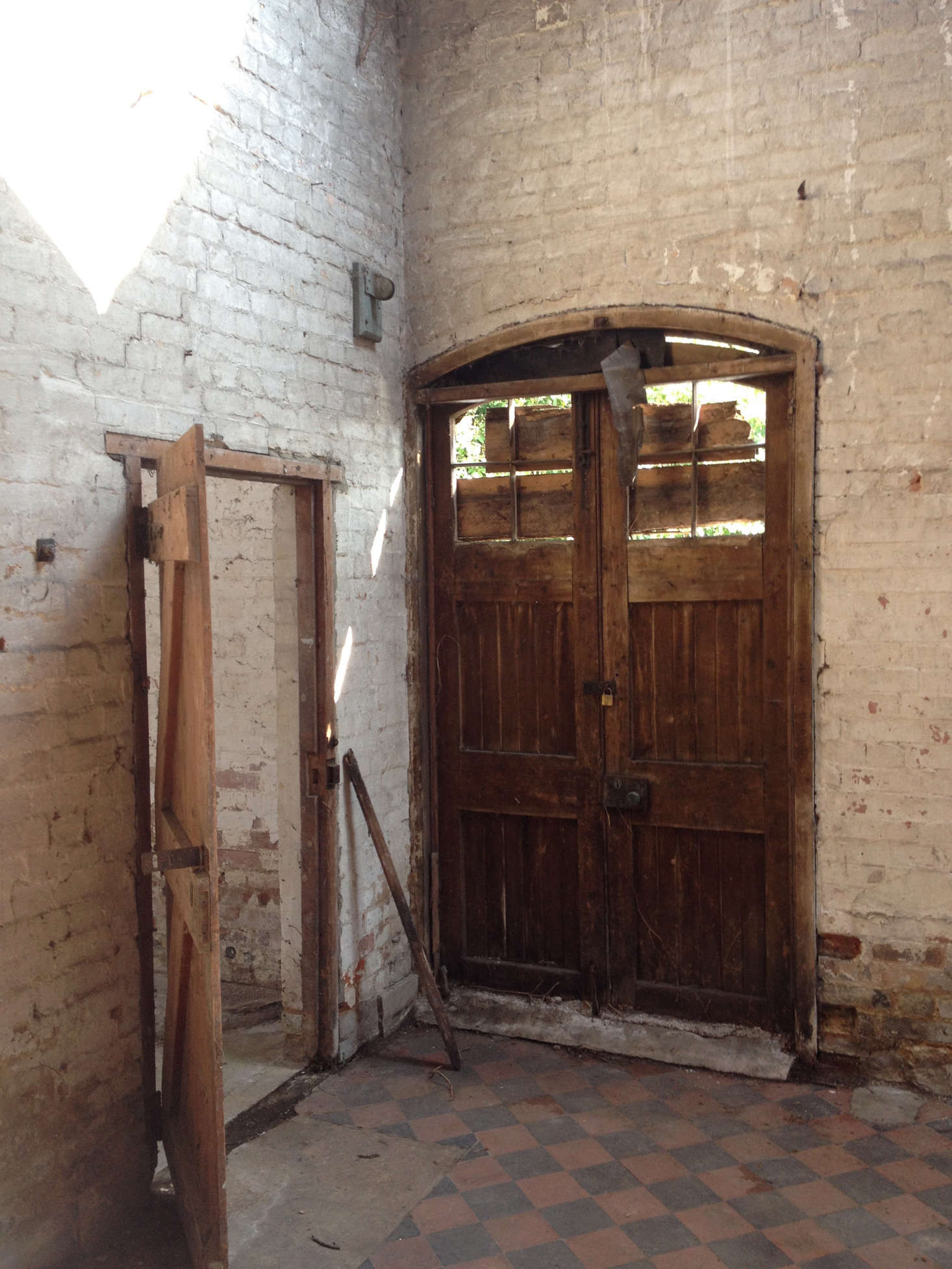 The original checkered floor. That’s the front door (left ) as it was. Photograph by Sandy Suffield.