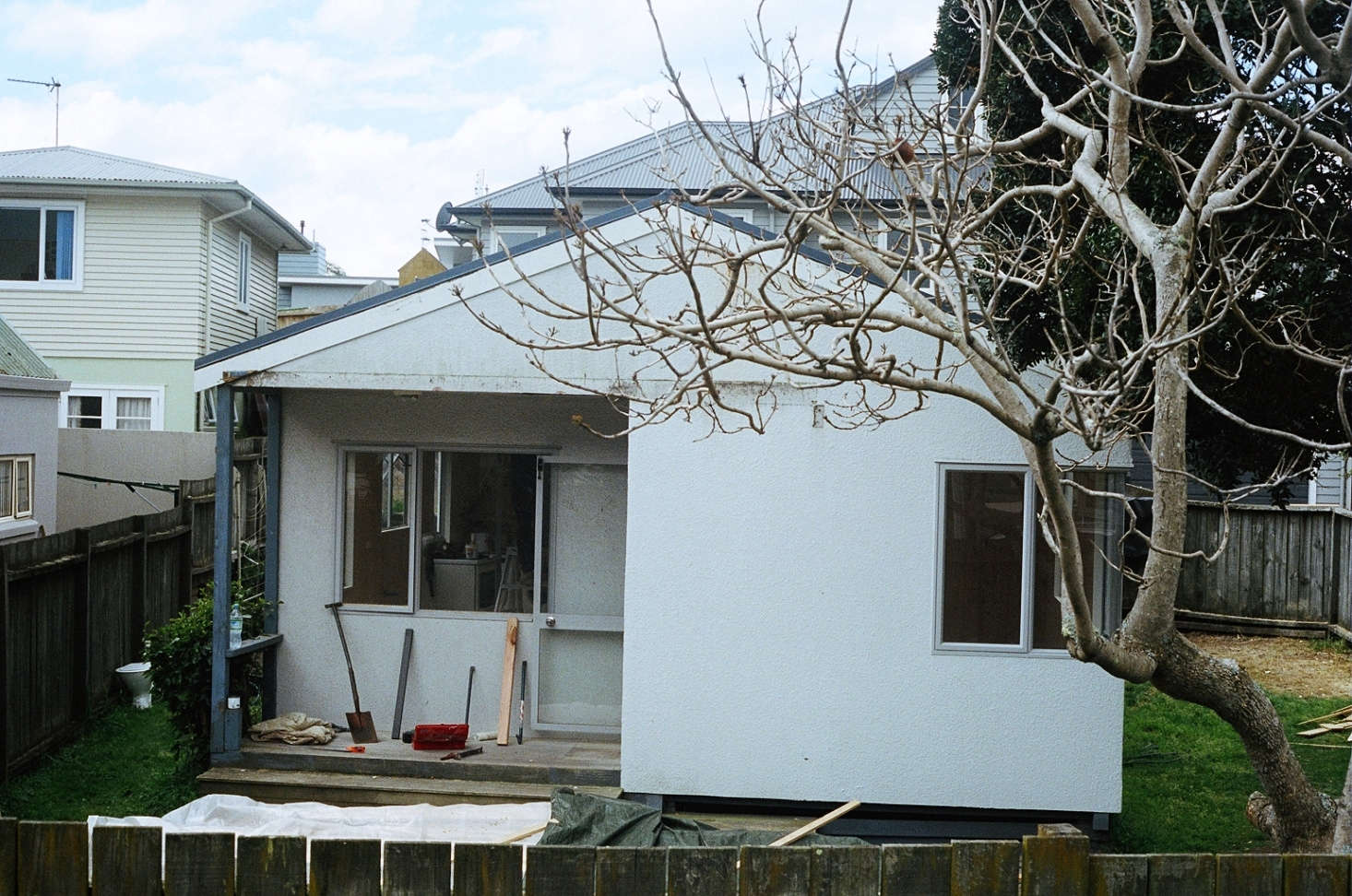 The builder who put up the house stopped by and told George and Will it had been his first project. They reoriented the front door and windows and removed the exterior plaster finish before applying the shiplap cladding.