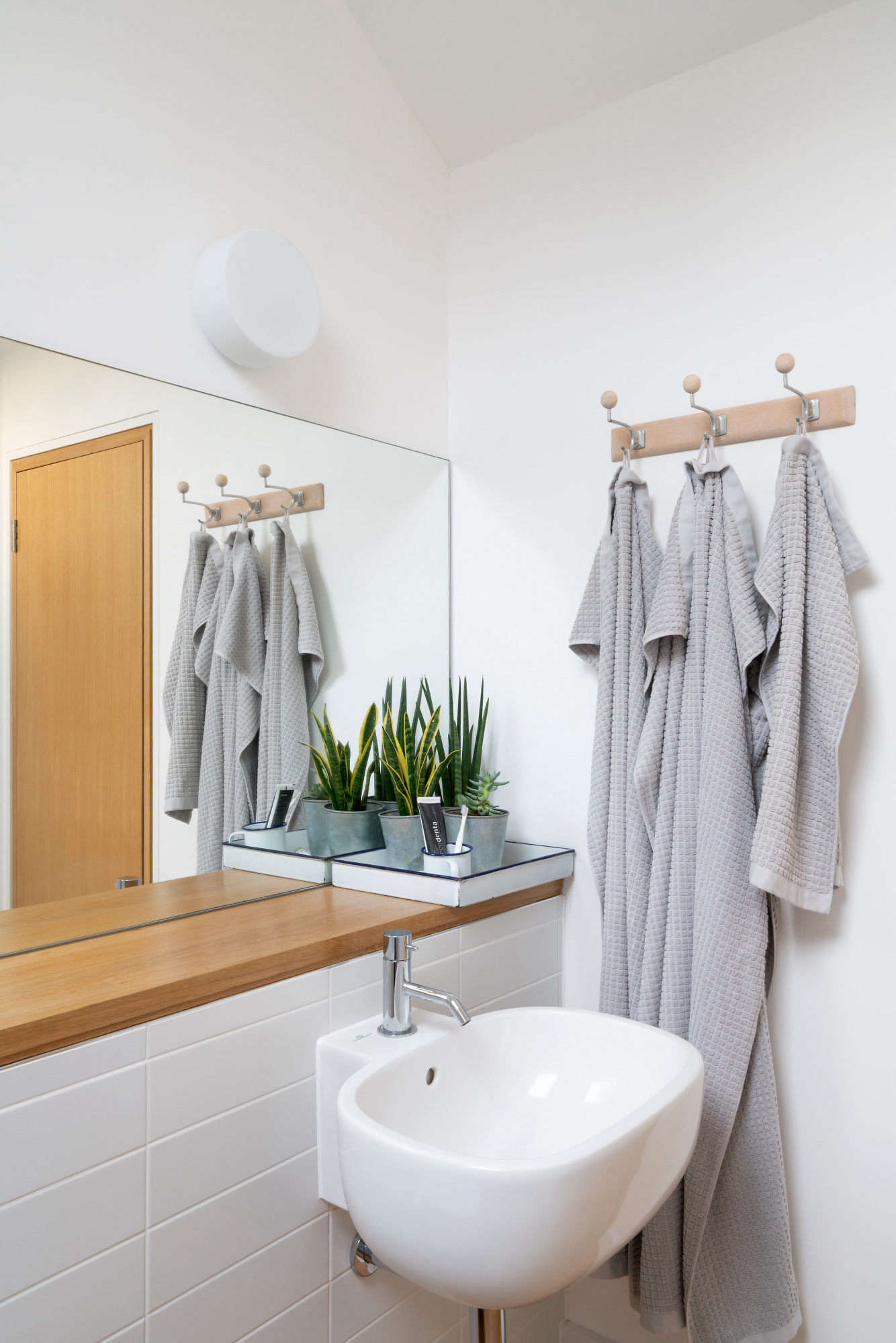 In the upstair bath, elongated matte brick tiles—Rhian 30 x 10 from Walls and Floors—set off a Pozzi Ginori Citterio basin ordered from ViaDurini. Not shown: the room’s large soaking tub.