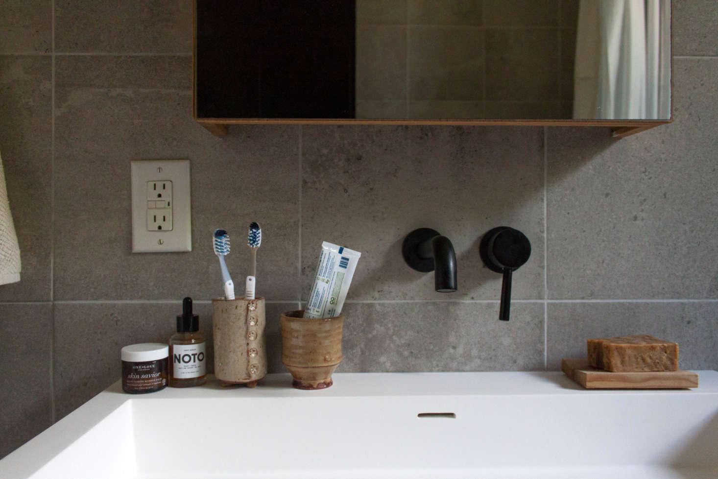 “The tile was sourced from a local shop, and it’s now discontinued. We learned that the hard way when a few of the tiles had to be replaced. Luckily my father-in-law found some,” says Gabi. The medicine cabinet is from Wet Style. The ceramic vessels are by Wade Franklin.