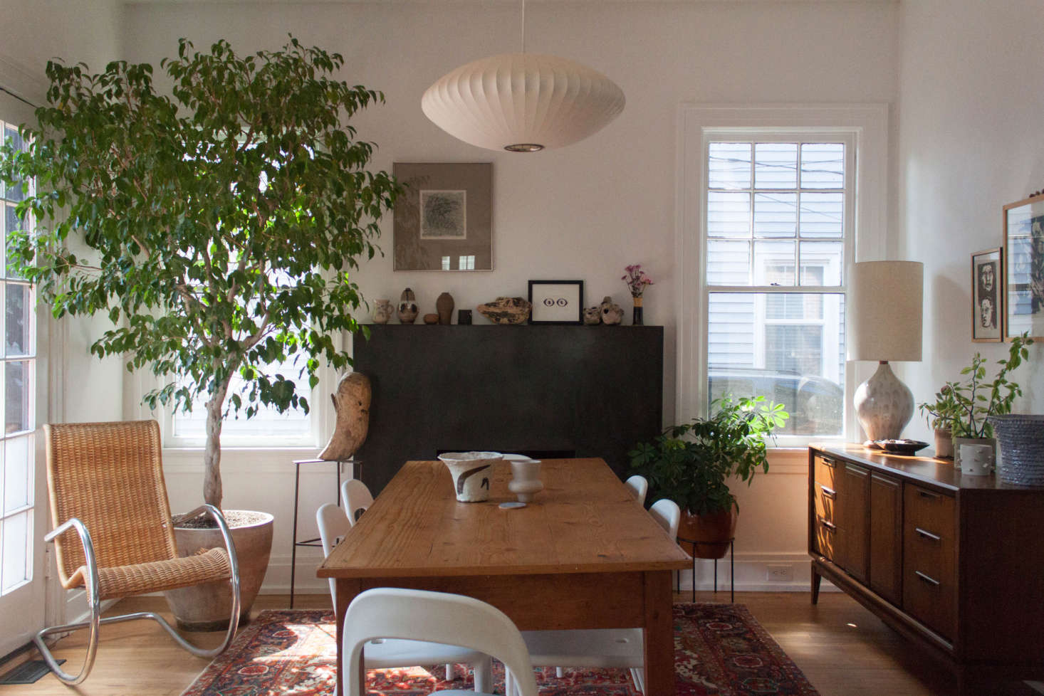 A custom concrete fireplace mantle provides a dark counterpoint to the otherwise light and airy room.
