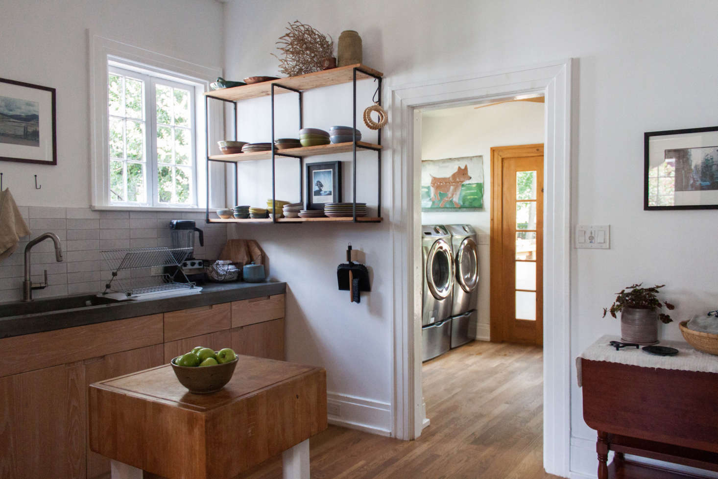 The wall-mounted shelving is by Blake Avenue. Under it is a Good Thing dustpan and broom on a hook by Iris Hantverk.