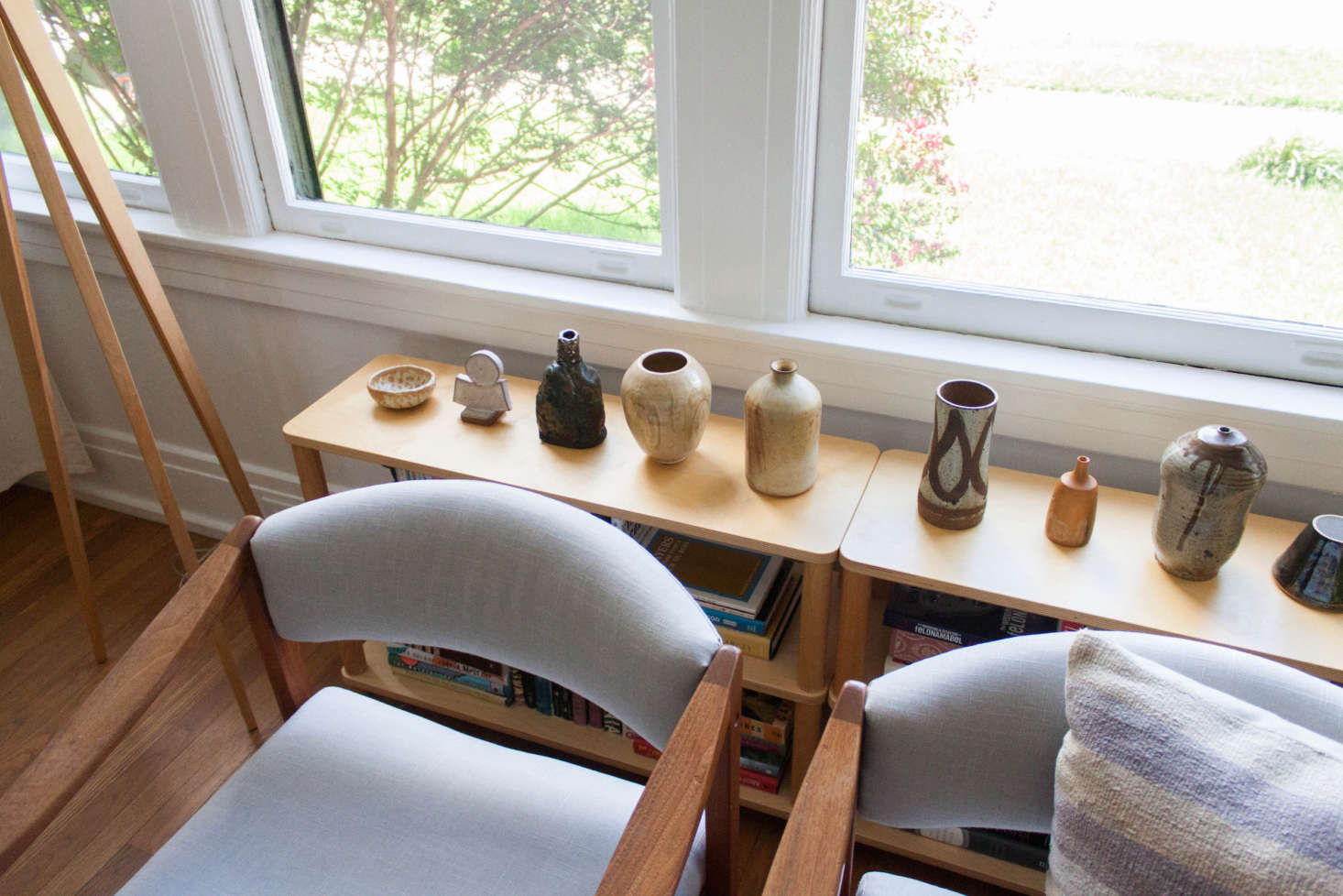 Gabi had the vintage armchairs reupholstered. She collects pottery—both secondhand and new from local potters—and displays them throughout her home.