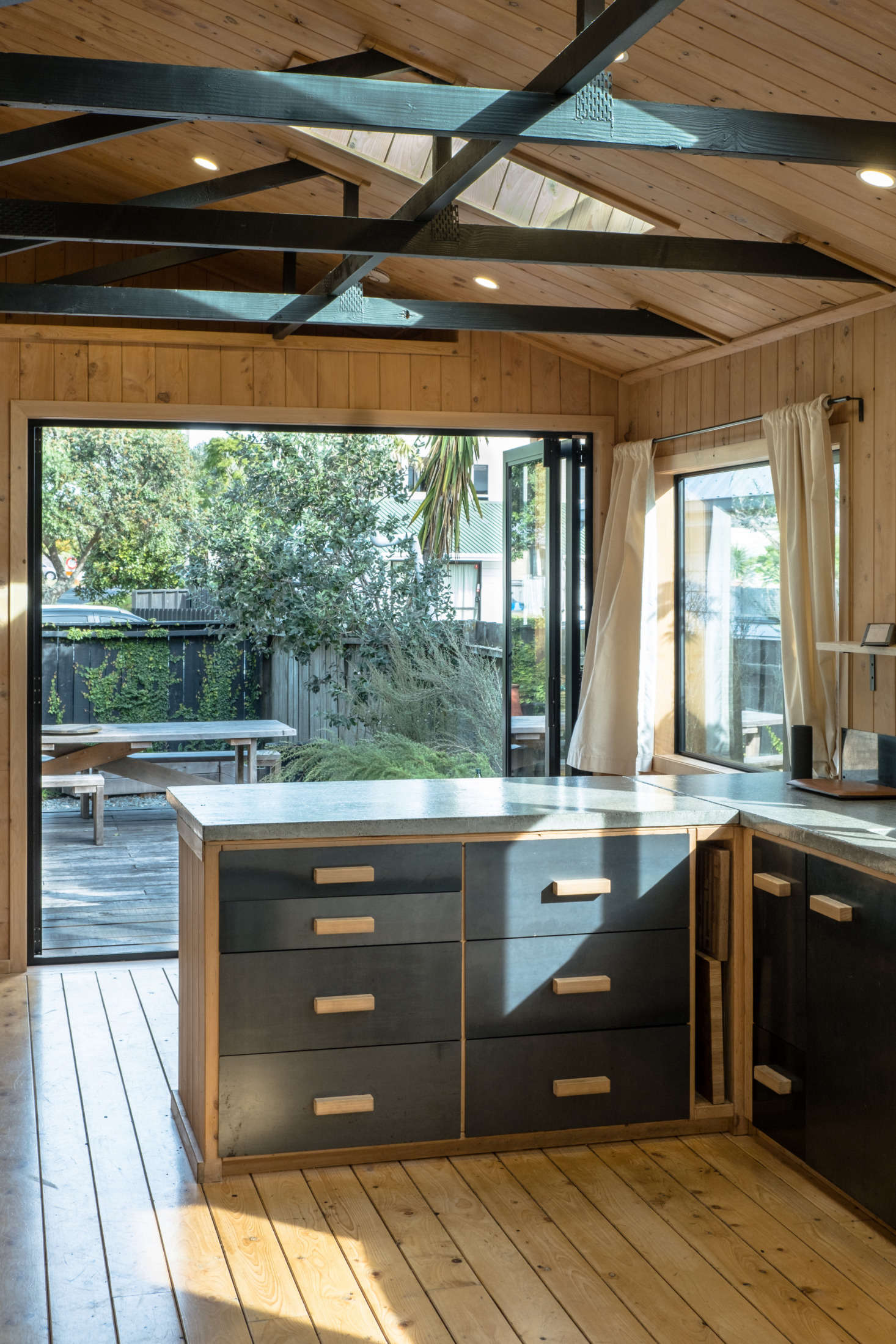 The kitchen island is framed with the same wood used throughout and the drawers are plywood with steel fronts. George and Will poured the concrete counter themselves in their workshop: “it’s the first one we ever made and is actually rather rough, but it gives the room lots of character.”