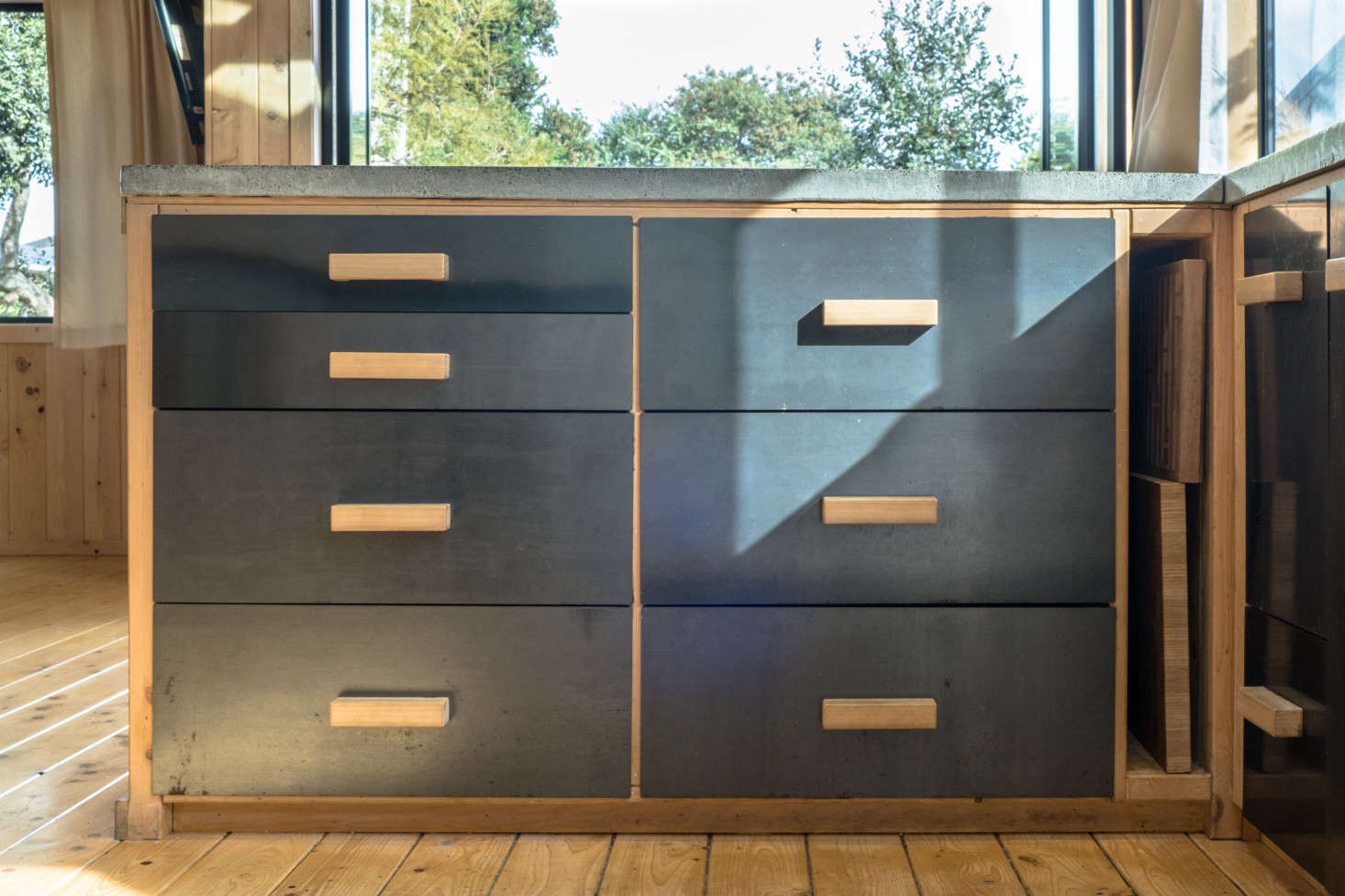 The steel-fronted drawers have handmade wooden pulls. In hindsight, George says, it would have been more cost-effective to buy kitchen cabinets than to build them: “sometimes doing it yourself actually costs more.”