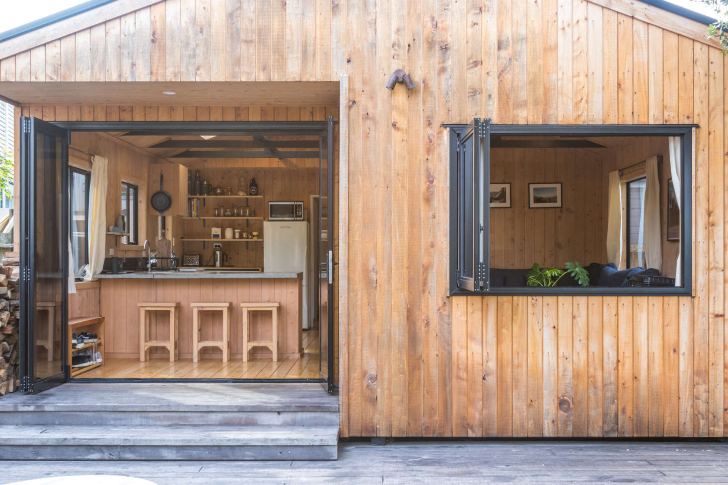 Double-glazed bifold doors and a new window open the living area to the deck.