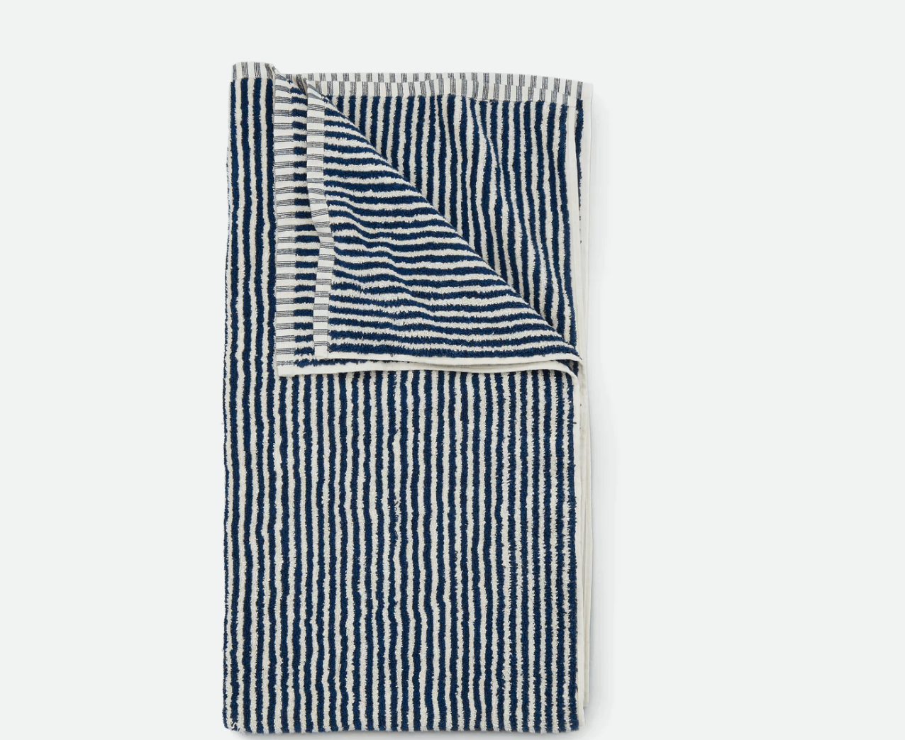 The Striped Beach Towel from Huckberry is available in navy/cream (shown above) or spring green/cream; $29.98.