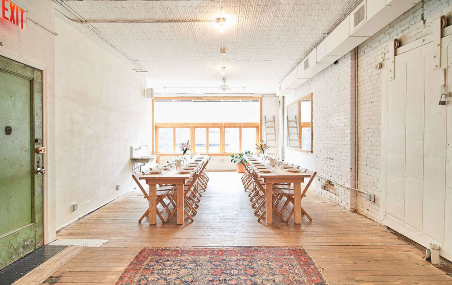 The dining space. The green door is original to the building and was left untouched. The wood floors are also original. “Where the original wood had rotted, I filled it in with tile instead of wood, in whatever shaped was needed,” says Poe.