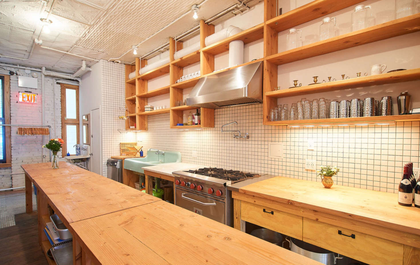 The fully stocked chef’s kitchen. Clients can sign up for a complete family-style dinner, or they can bring their own chef and food. “The green sink is original to the building but not the space. When we were building Lee’s, the landlord was demolishing another space upstairs that had all kinds of beautiful original character. I rescued that sink out of their dumpster,” says Poe.