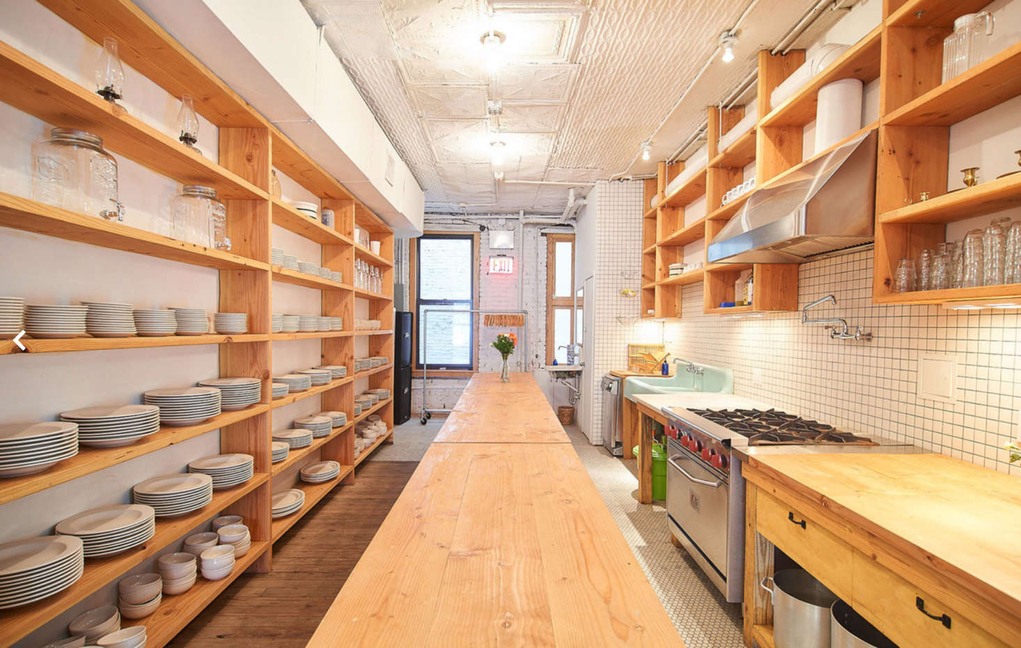 All the wood shelves and tables were designed by Poe. The built-ins in the kitchen are his homage to Donald Judd’s bookshelves.