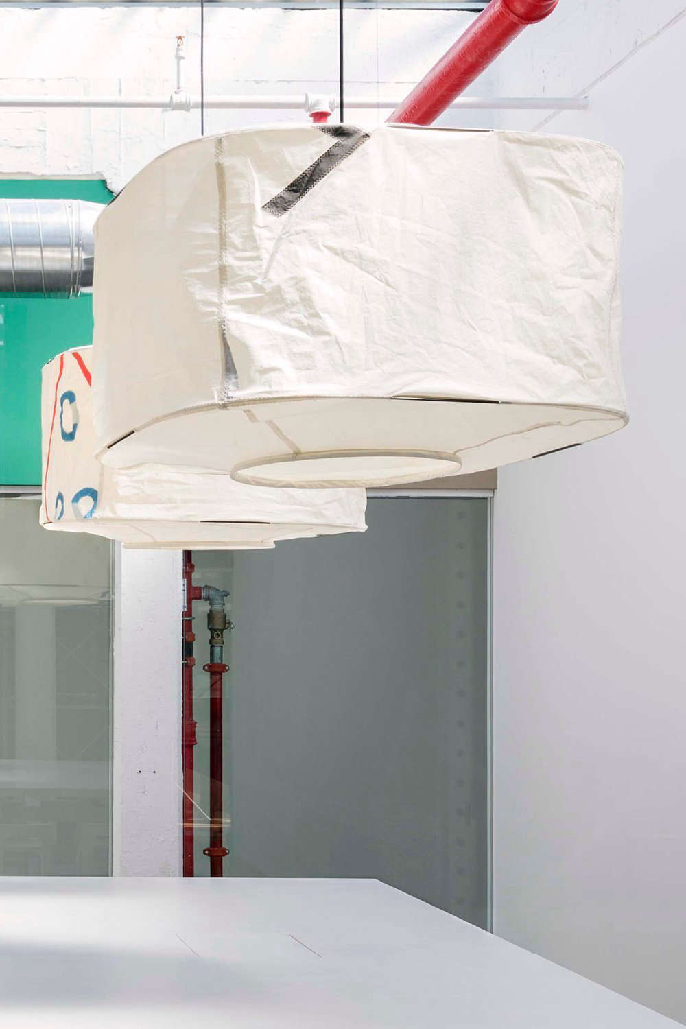 The 36-inch-square AllSew Square Pendant Light is made from reclaimed sails; contact Rich, Brilliant and Willing for pricing.