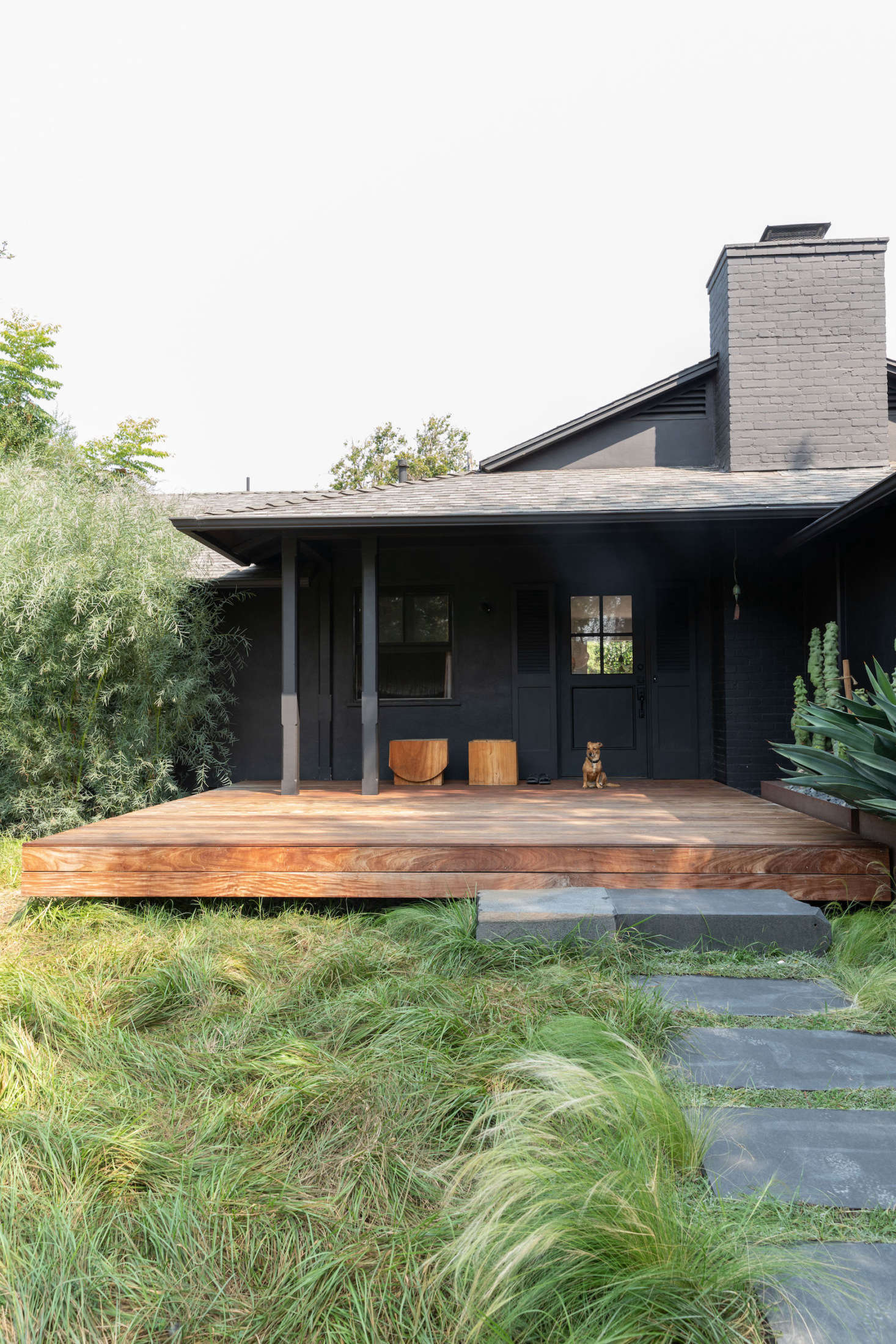A tousled lawn and black exterior immediately let visitors know this isn’t an average suburban home.