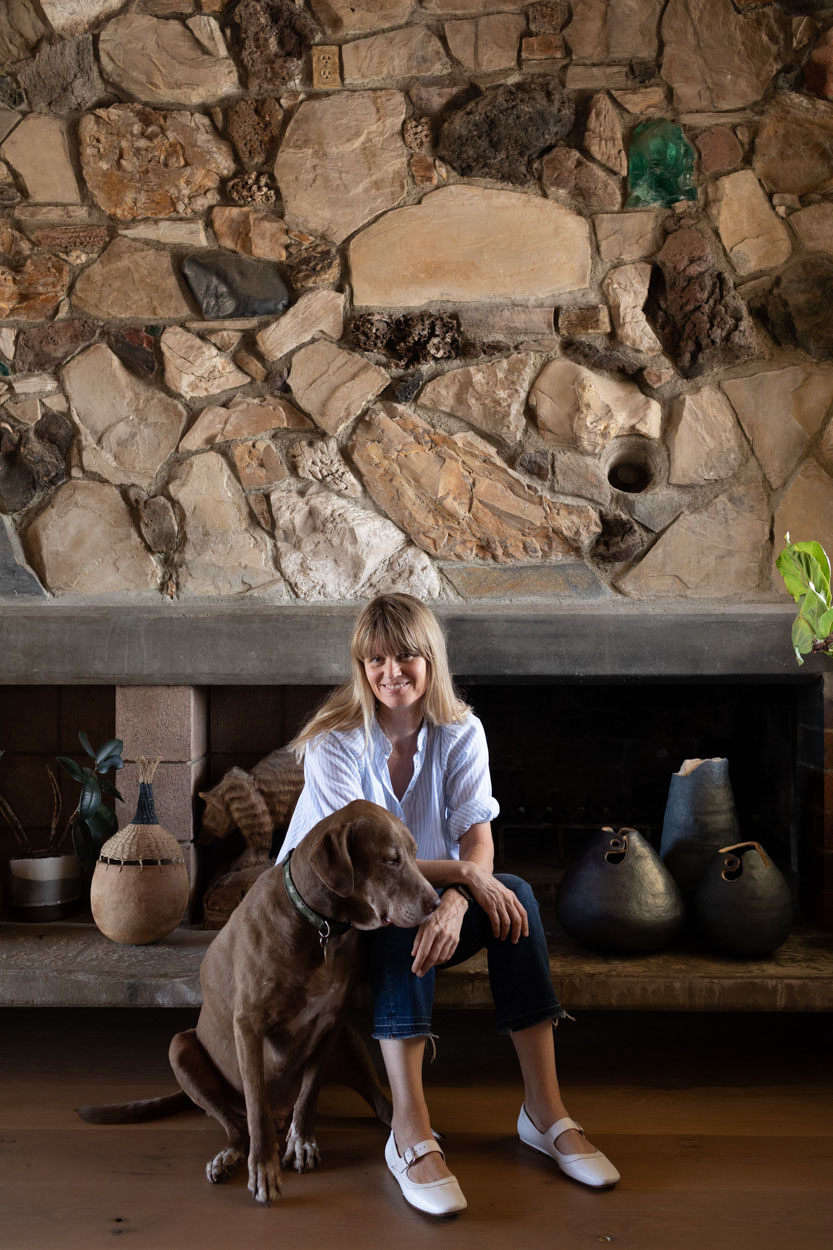 Brownie and Wilkinson in front of the fireplace, integrated into a stunning stone wall.