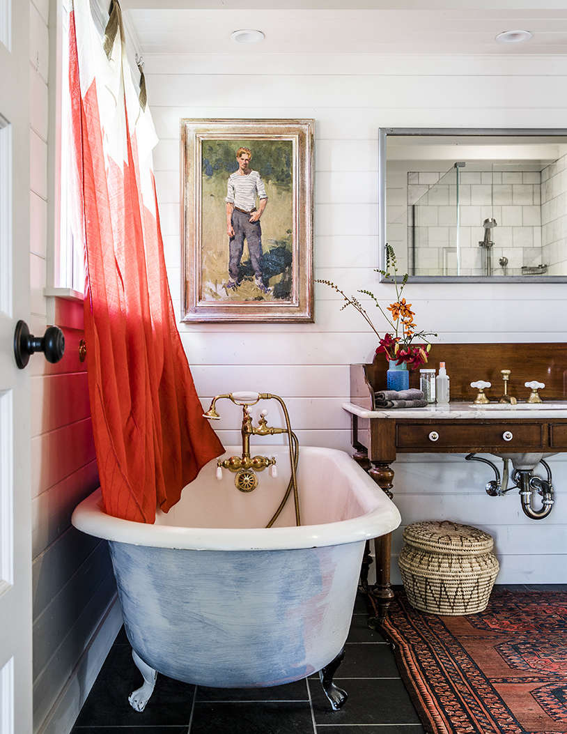 Also from Second Use: the circa-1920s tub in the master bath. A pair of signal flags found in Provincetown make charming curtains.