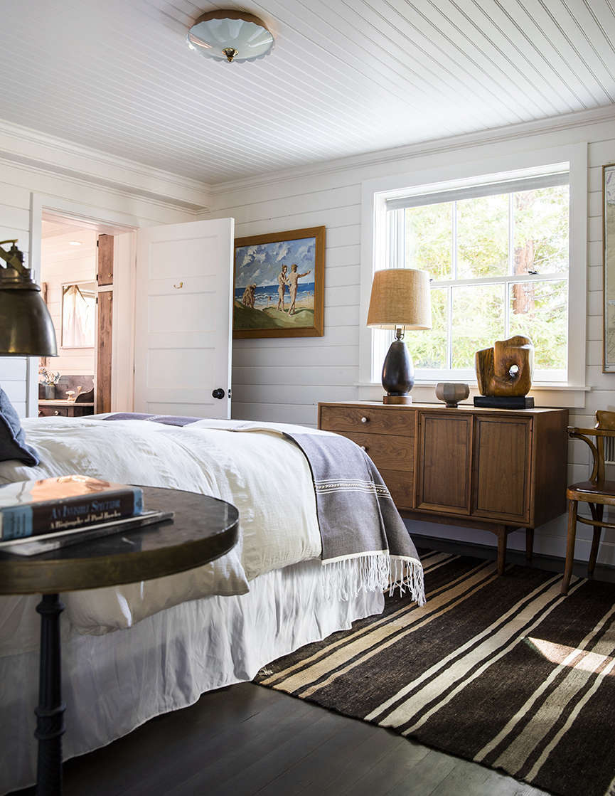 The master bedroom with an ensuite bath. The home’s reclaimed doors are from Second Use.