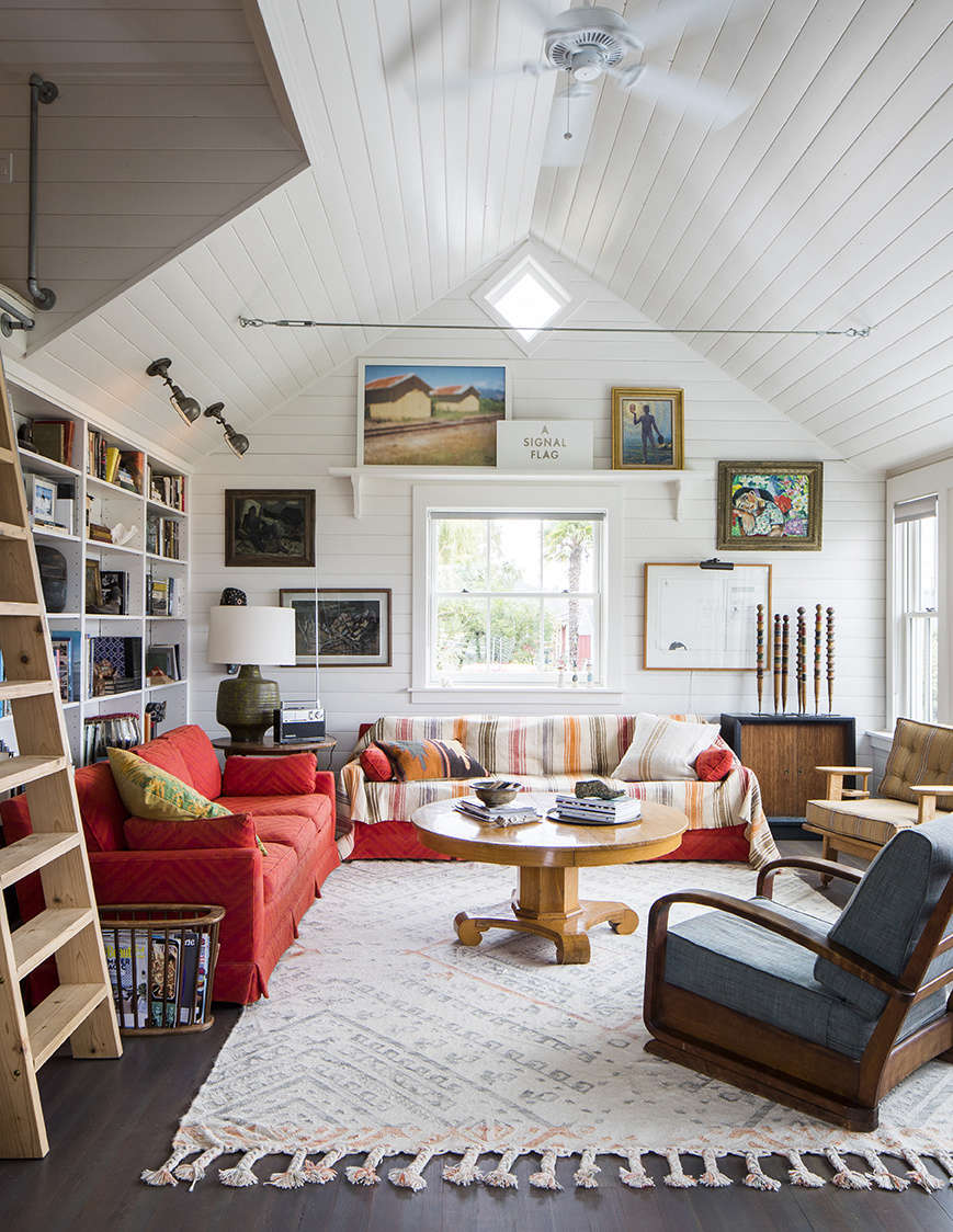 Pfeiffer’s favorite room, the living room with its library wall. The design team sourced a mix of antiques and primitive nautical objects for the interiors.