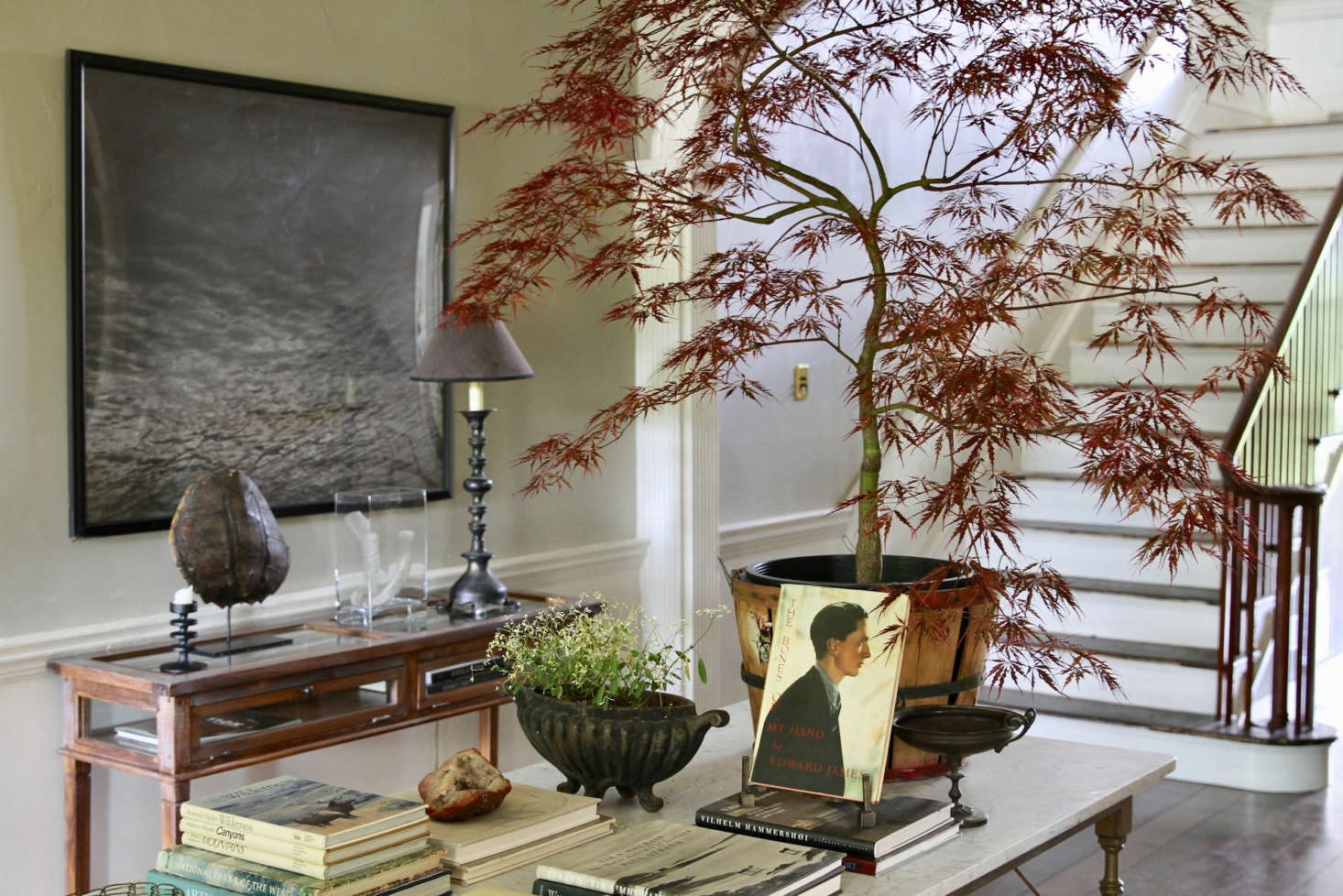 The well-appointed center hall feels at once homey and sophisticated. “We were lucky to purchase a few pieces from the sellers of the house, which we love. Overall, we have a mix of pieces and styles taken from our other homes, some family heirlooms, and flea market and estate sale finds,” says Scott.