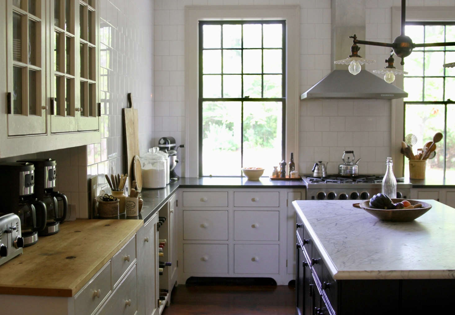 The kitchen cabinets are painted Benjamin Moore’s Collingwood, the island Twilight Zone.