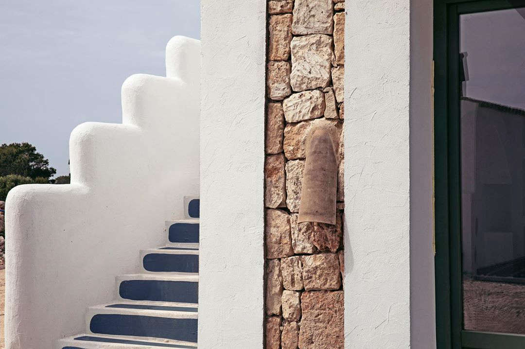 The villas were rebuilt from historic farm structures: “they’re inspired by traditional Menorcan architecture but with some twists,” says Meilichzon. The stepped stair walls were her idea—”they’re something you may have seen in Greece.”