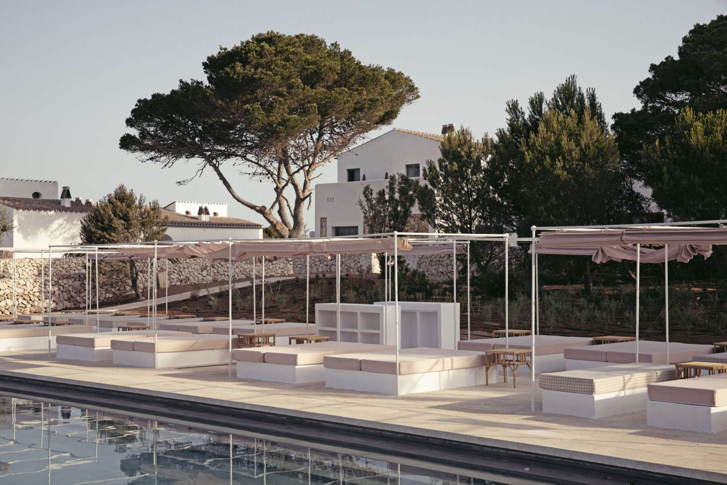 Canopied mattresses for one and two surround the 26-meter pool.