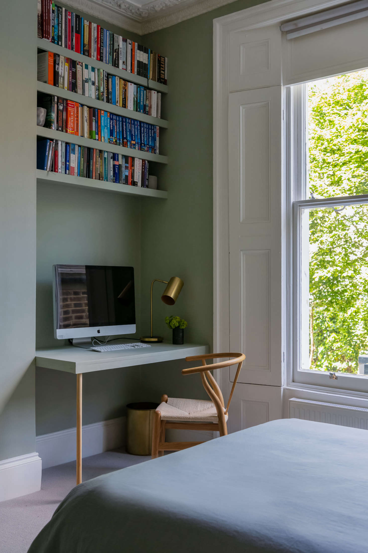 While the public living spaces are modern and sleek, the bedrooms, which are all housed in the existing structure, are more traditional, with Victorian high ceilings, decorative cornicing, and shutters. The second-floor guest bedroom (which turns into a den for Olivia and her boyfriend when the sleeper sofa is folded up) is painted Farrow & Ball
