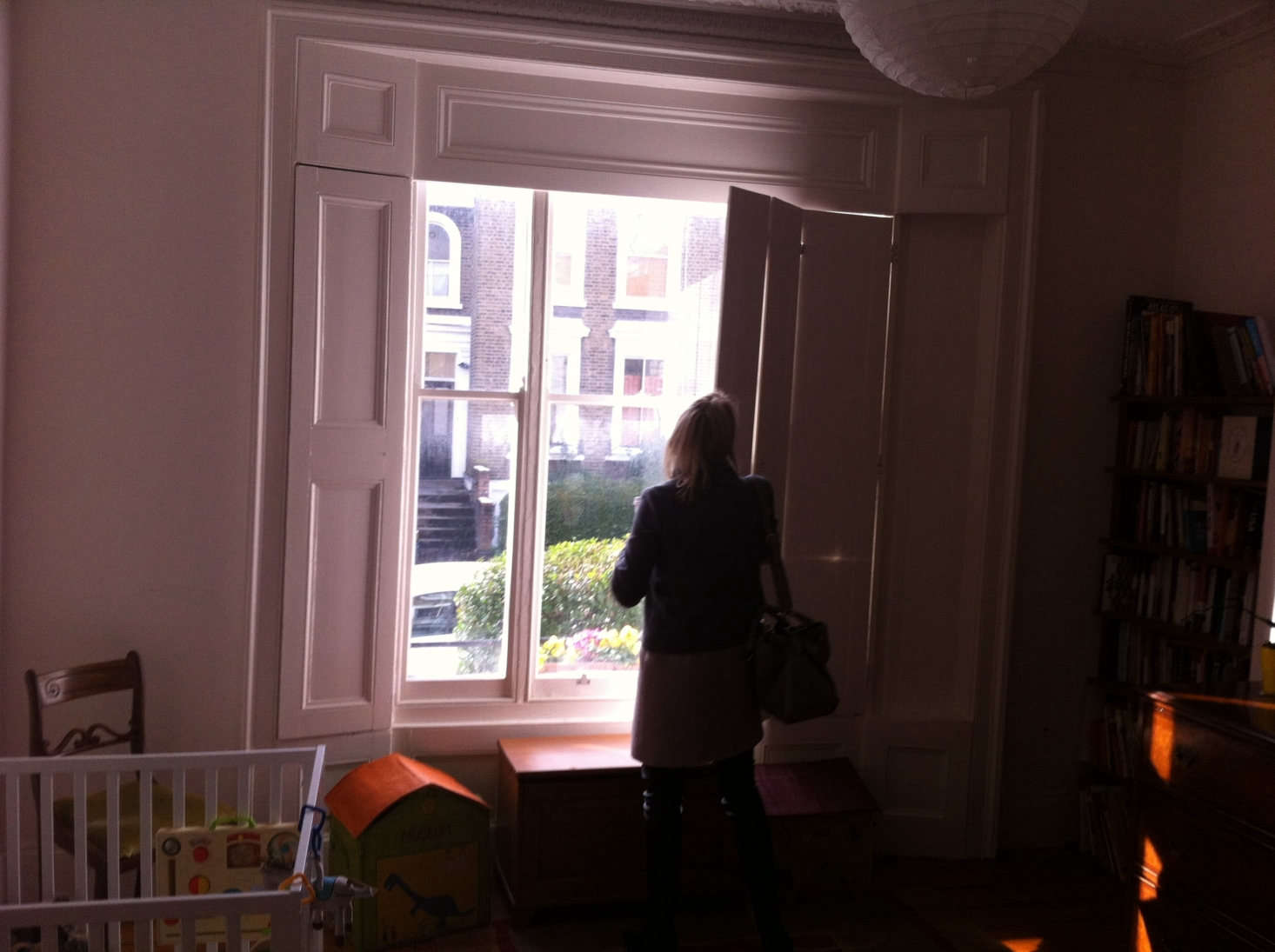 The traditional shutters and architectural details in the existing structure remain.