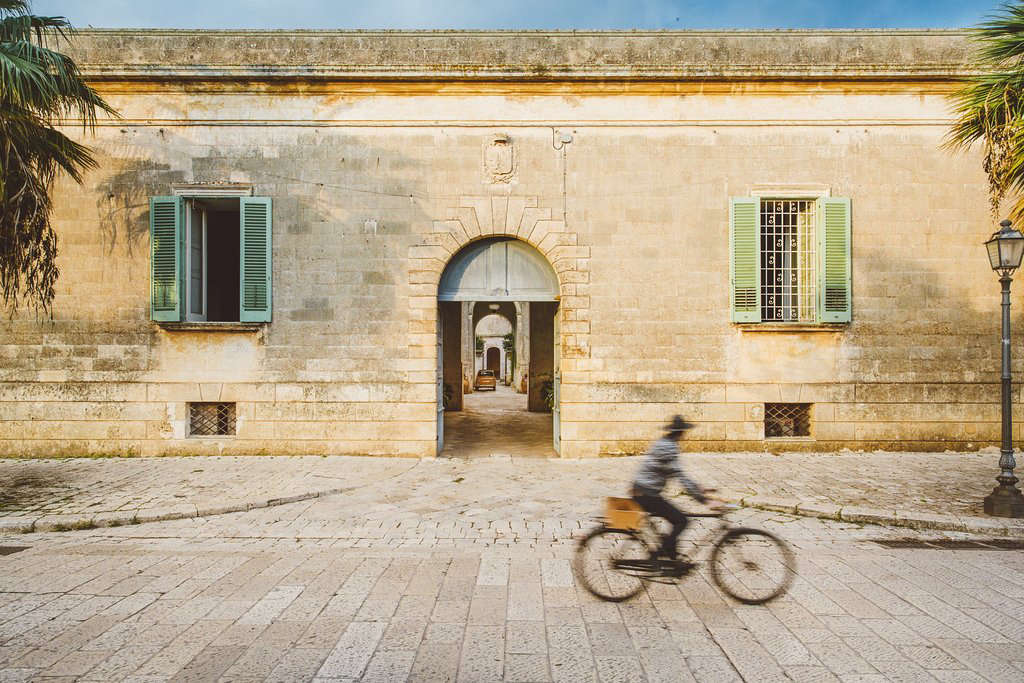 The dusty exterior of the hotel leads to a series of courtyards and rooms beyond.