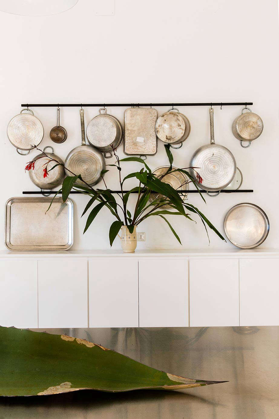 Utilitarian pots and pans become a practical display when hung from s-hooks.