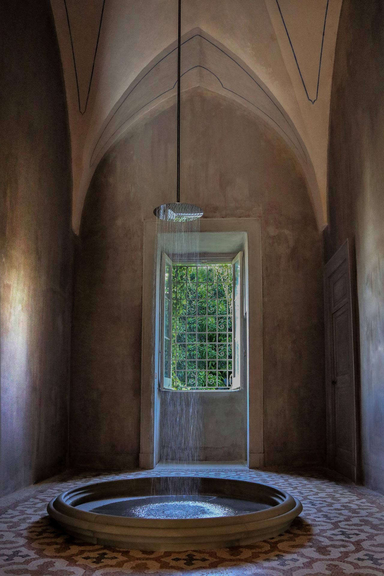 The team installed a modern-meets-ancient rain shower, with water falling from “an archaic source of water” into a lipped basin by the Milan-based artist Andrea Sala.