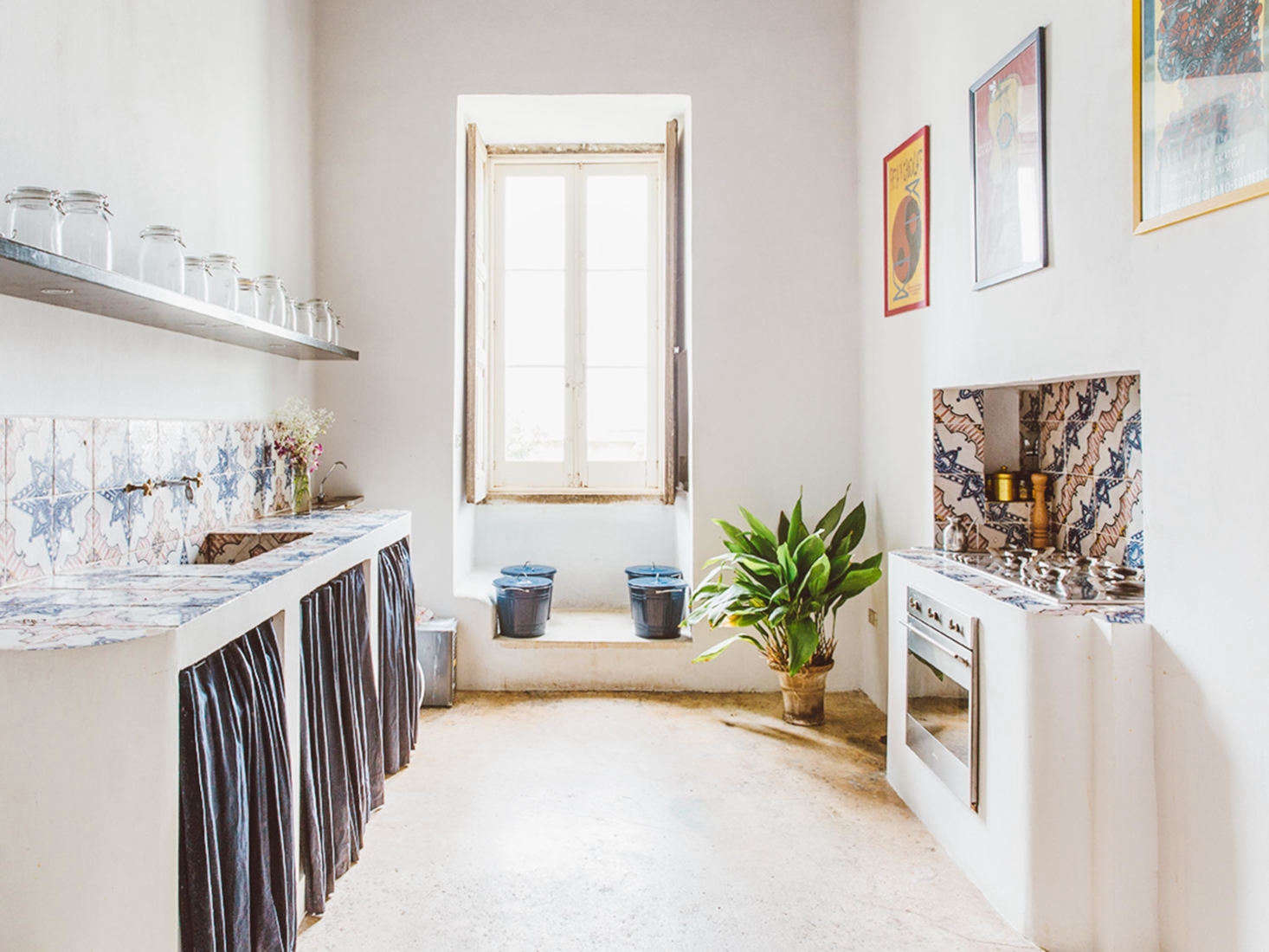 The Suite Apartment features a simple kitchen, with tiled countertops and backsplash and skirted storage.