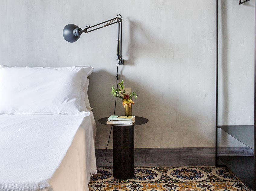 A wall-mounted reading lamp. When the interiors are this spare, the cords become part of the design.