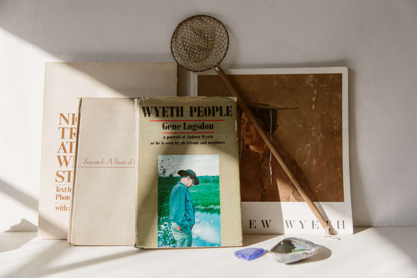 O’Rourke kept the bones of the space simple, and leaves the evocativeness to the tiniest details she places throughout the shop: vintage books on Wyeth, shown here; or, elsewhere, a miniature mirror (not pictured) and a children’s chair. “The small mirror I bought off of Etsy from a little shop in France,” she says. “I actually had no idea how tiny it was until it arrived, but it is just absolutely perfect in every way, even the little angle that it sits at.”
