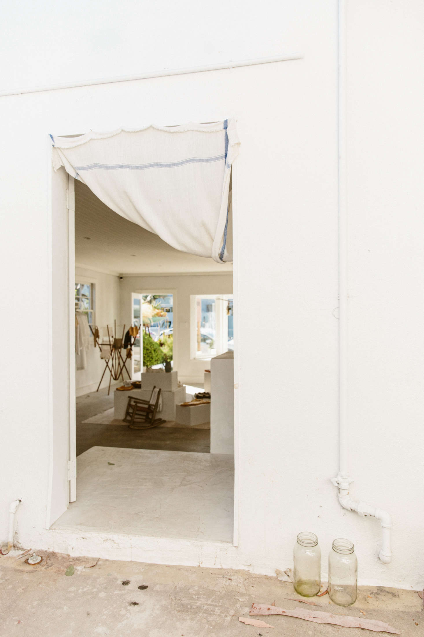 “The double doors lead to a back patio that we share with our neighbors and friends, Olderbrother,” O’Rourke says. She’s kept it spare, and keeps the doors open—save for another simple white cloth—to let in light and air.