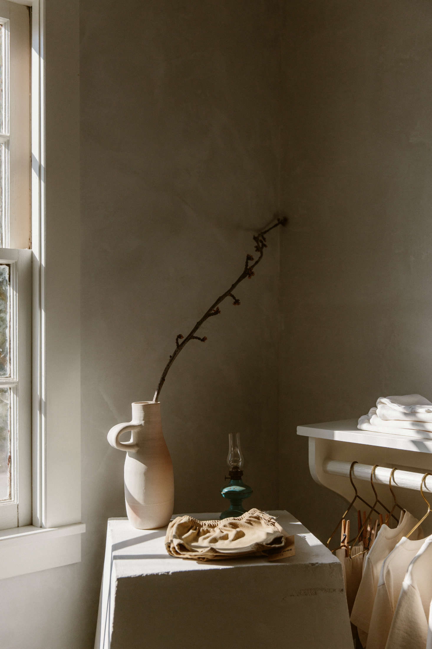 More tiny details: an oil lamp beside a ceramic vessel by ANK Ceramics.