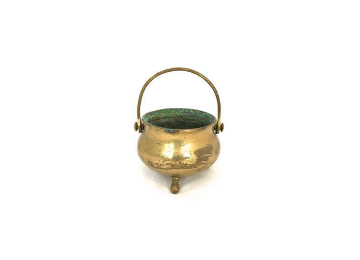 This Vintage Rustic Brass Cauldron has a diameter of 4.5 inches, perfect for corralling flatware; $31.41 on Etsy.