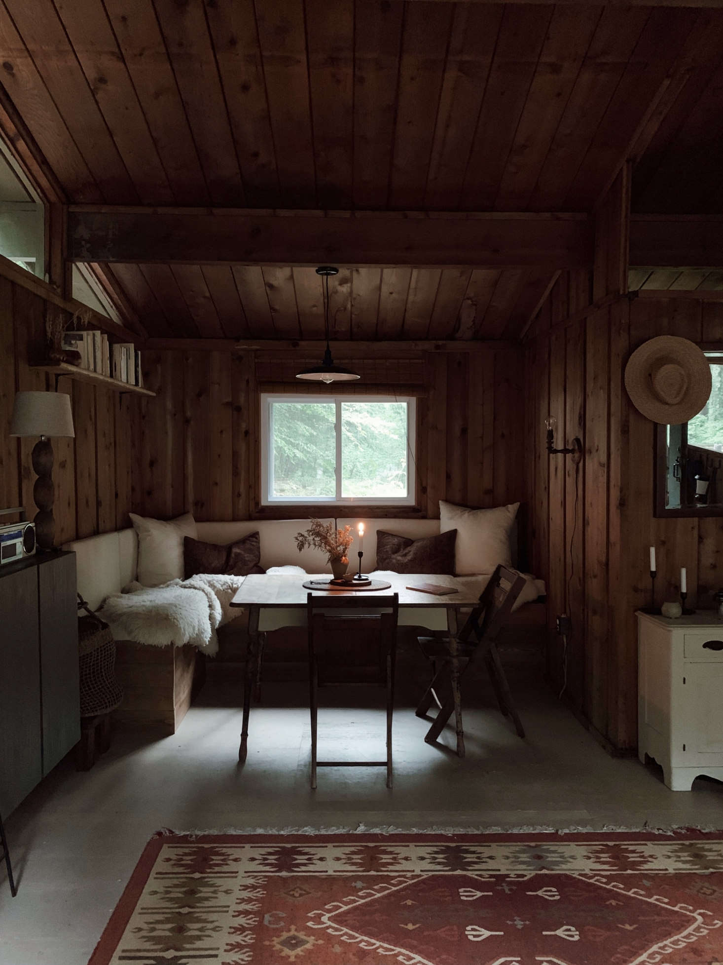 The dining nook is the couple’s proudest DIY. “We designed it ourselves after watching a number of different YouTube tutorials,” Saunders says. “The frame is 2x4s and plywood, and I made the removable cushions out of plywood, upholstery foam, and canvas. I covered it in sheepskins to make it extra cozy for us and also for our dog, who loves to nap there.”