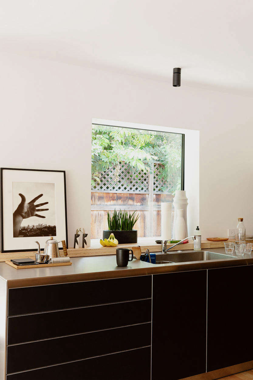The linoleum-faced cabinets and stainless-steel counter and sink are from Bulthaup’s B3 line. “I opted to go without any handles, so the space has a minimal, sculptural quality à la Donald Judd,” says Yanai. The faucet is by Fantini.