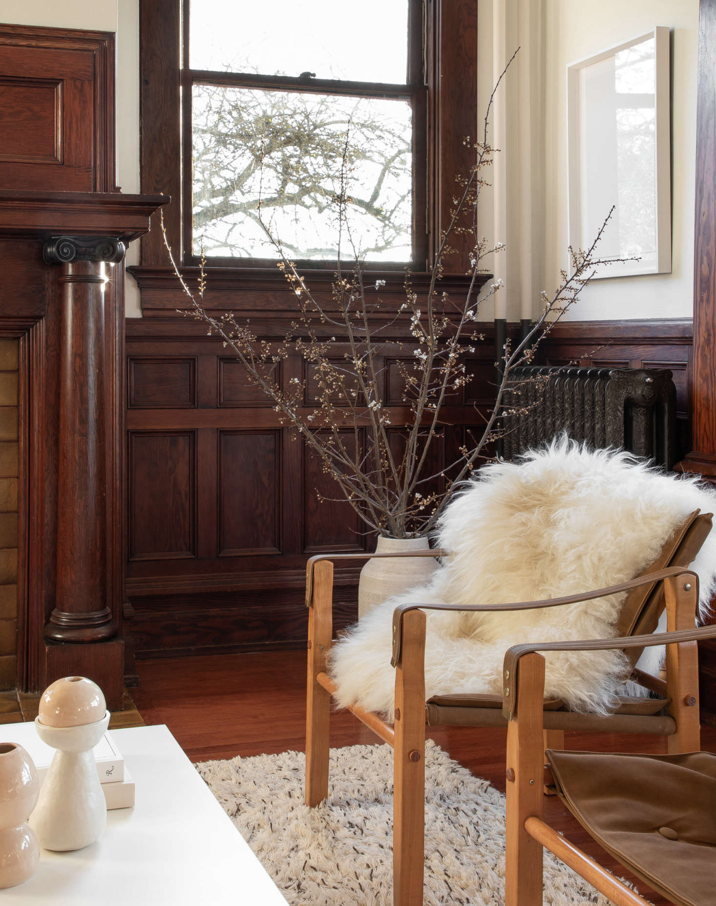 One of the refurbished radiators stands behind a pair of vintage safari chairs. All of the Icelandic Sheepskins are from Hawkins New York.
