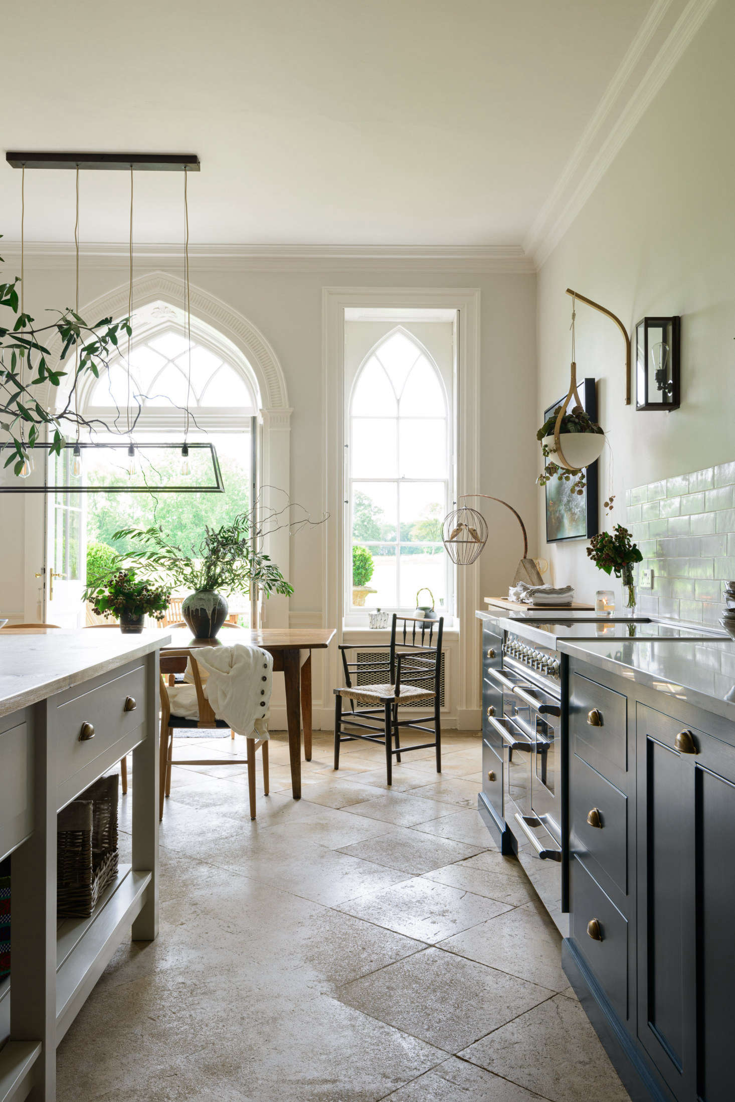 The past (Gothic windows and original limestone floors) coexist with the new updates.
