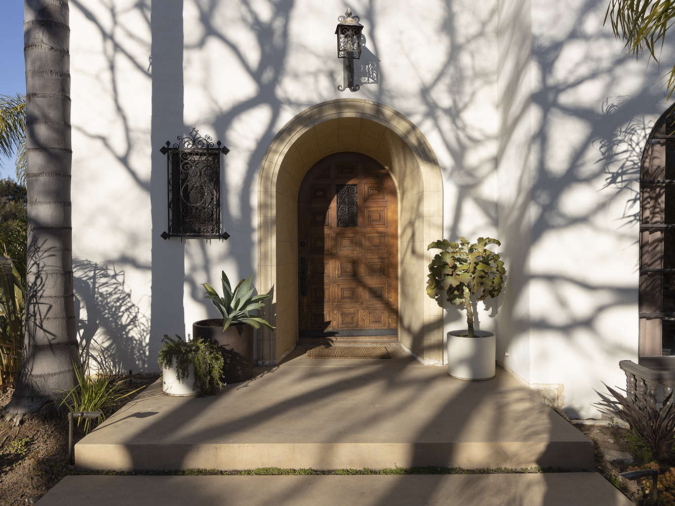 The house sits on a corner lot and has its original paneled front door and side peep-hole window. It was built for the founder of the Ralph