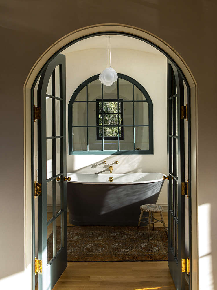Three arched entries now lead to the bath, shower, and WC. 
