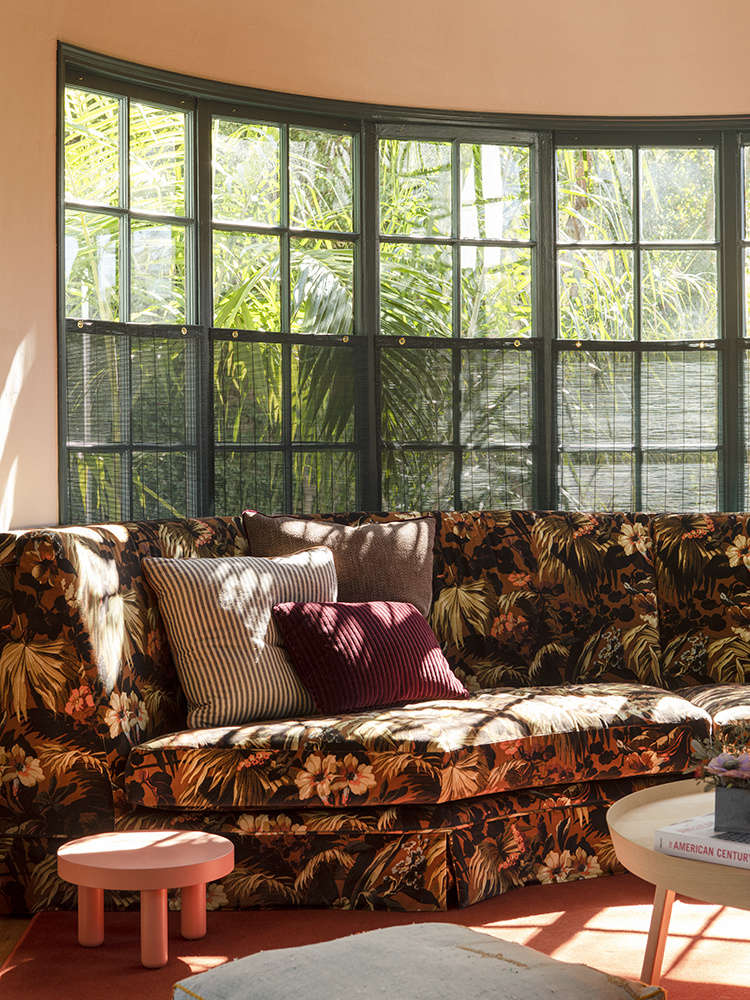 Beckoning from the living room is the showpiece of the family room, a custom sectional in a bay window upholstered in a House of Hackney velvet called Limerance (initially deemed too pricey, it was subsequently discontinued in the colorway they wanted and was being offered at a steep discount.) 