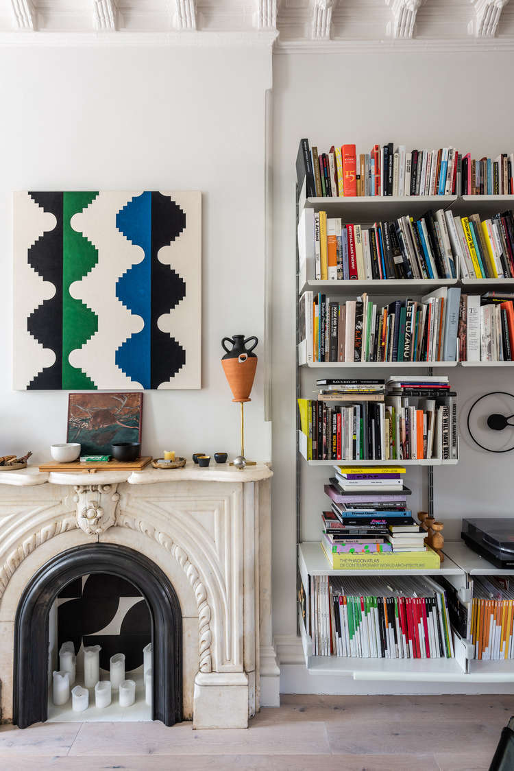A wall of Vitsoe shelving holds the couple
