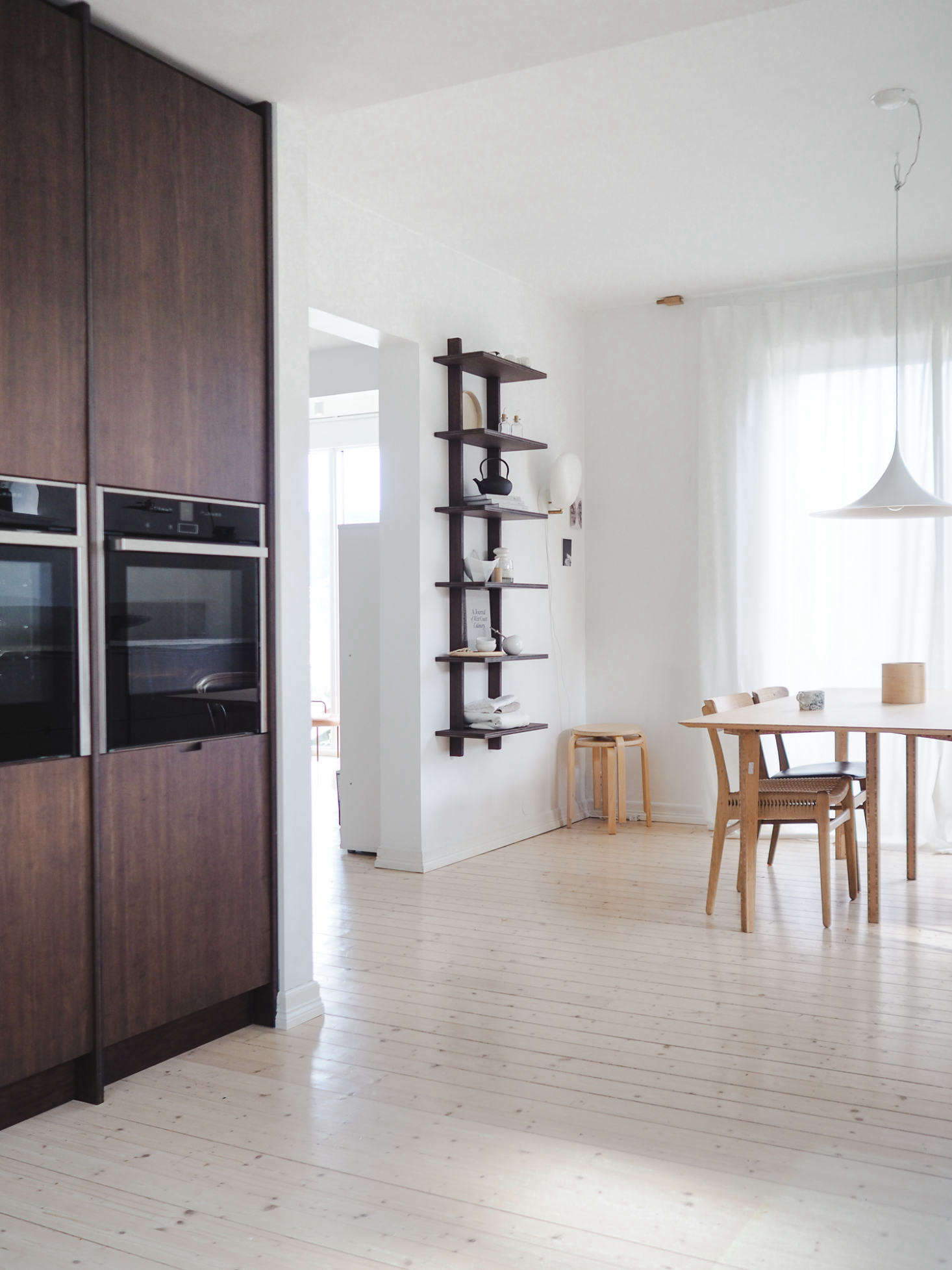 Neff wall ovens are incorporated into a pantry wall. The Ask og Eng A-7 Cross Shelf comes in large (shown here) and small (shown over the counter).