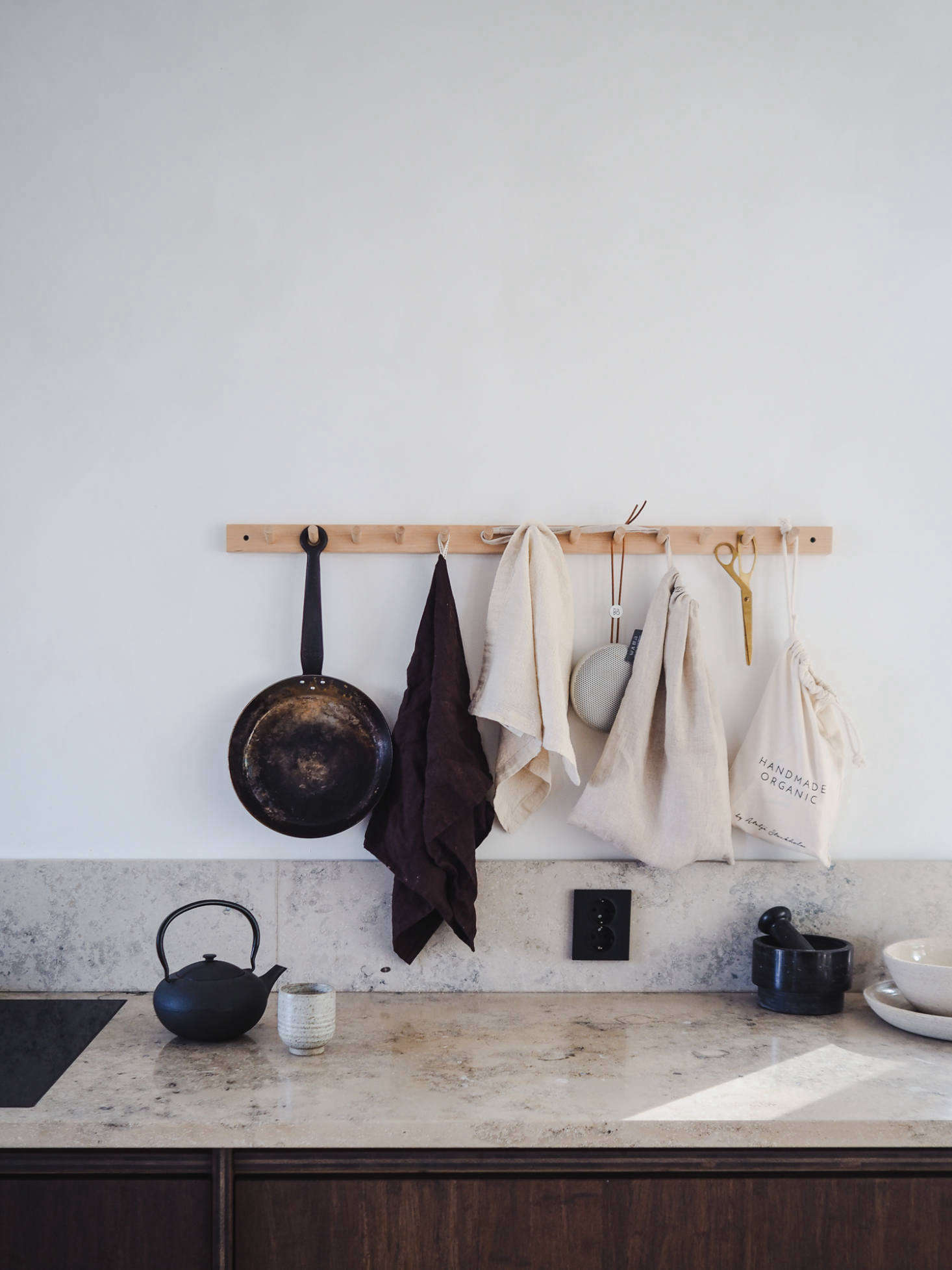 A Birch Hook Rack keeps crucial kitchen tools off the counter. Discover more of the many uses for peg rails in our book Remodelista: The Organized Home, and for sources see Object Lessons: The Shaker Peg Rail.