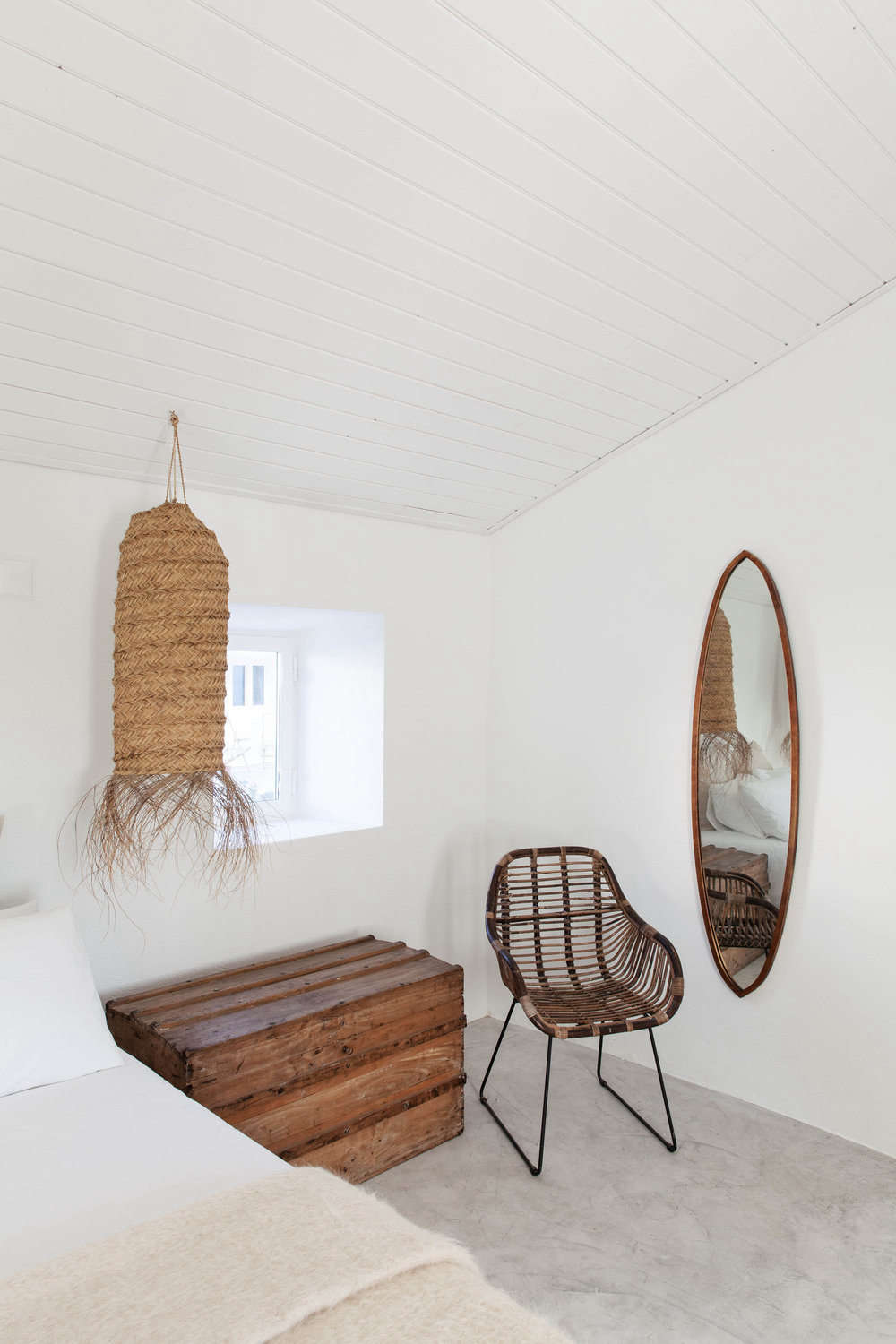 A mohair throw and oversized woven pendant add texture to another bedroom.