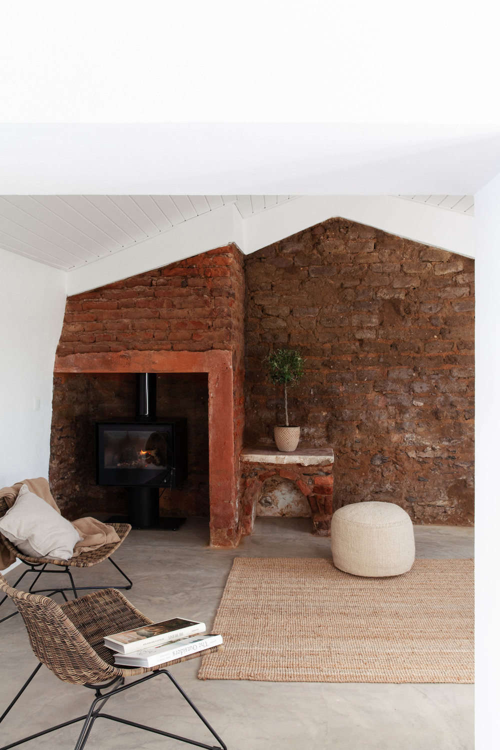 Another lounge area has original exposed-brick walls and a tucked-away wood stove.