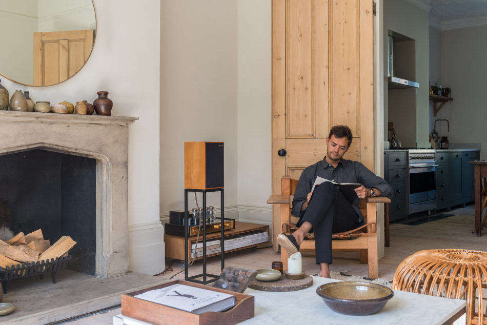 Paul relaxes on his favorite piece of furniture in the home, the Spanish Chair by Borge Mogsensen. The speakers are a BBC design, from Harbeth UK; the amplifier, on top the low console, is from Jadis in France. 